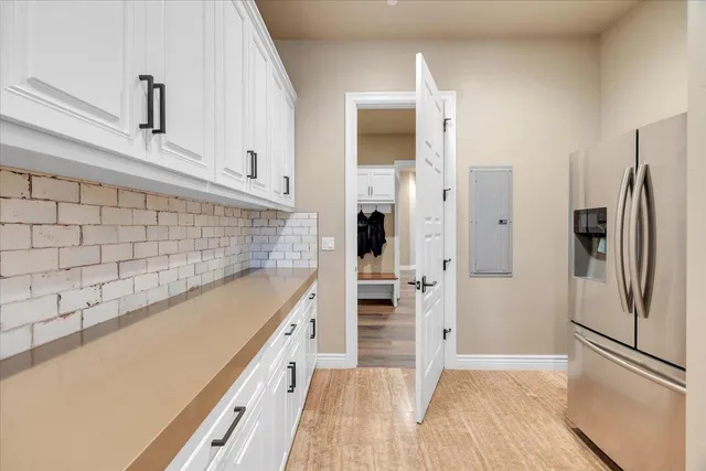 a living room with furniture floor to ceiling window and a flat screen tv