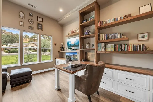 a living room with furniture and a view of kitchen