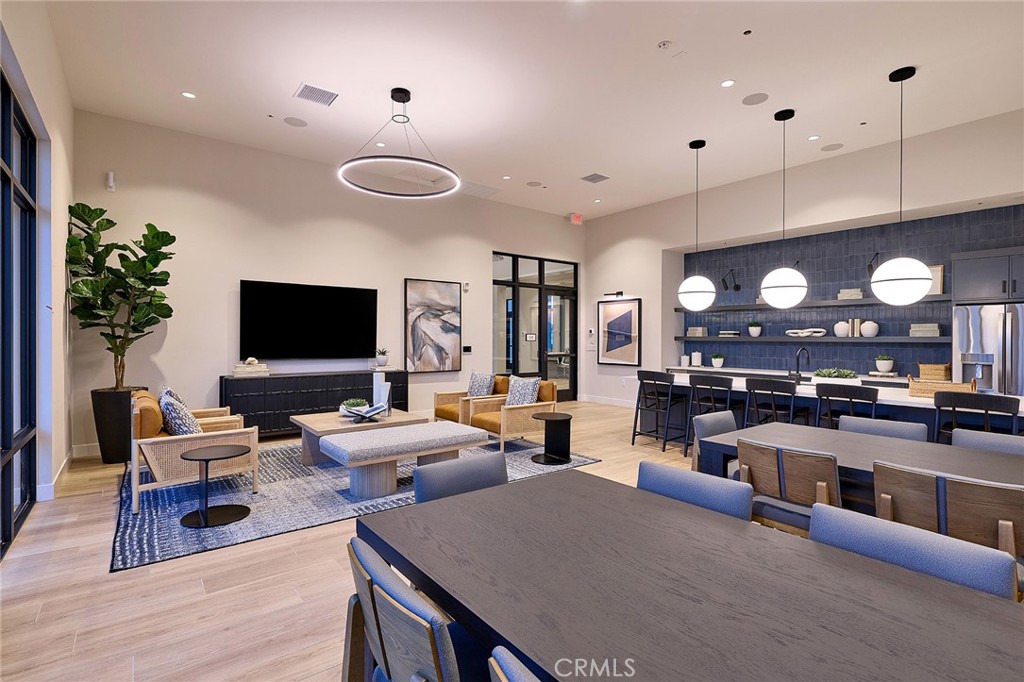 12706 Rosemount Road Eastvale, CA 92880 - Photo 21 of 25 a living room with furniture a flat screen tv and kitchen view