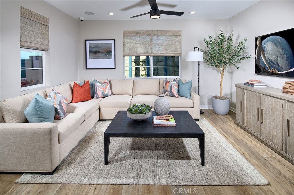 12706 Rosemount Road Eastvale, CA 92880 - Photo 3 of 25 a living room with furniture a flat screen tv and a rug