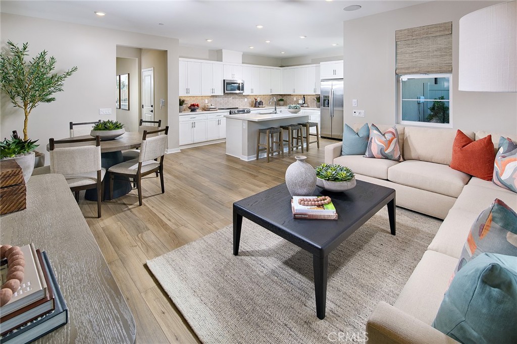 12706 Rosemount Road Eastvale, CA 92880 - Photo 4 of 25 a living room with furniture kitchen view and a table