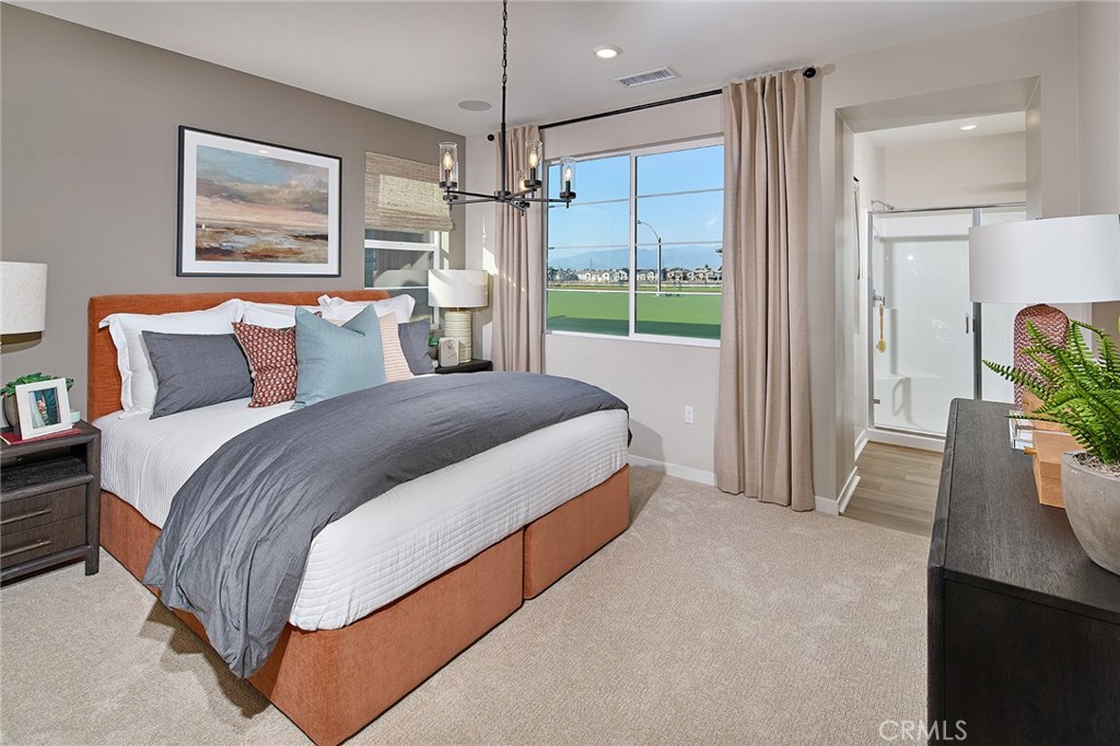 12706 Rosemount Road Eastvale, CA 92880 - Photo 8 of 25 a spacious bedroom with a bed and a window