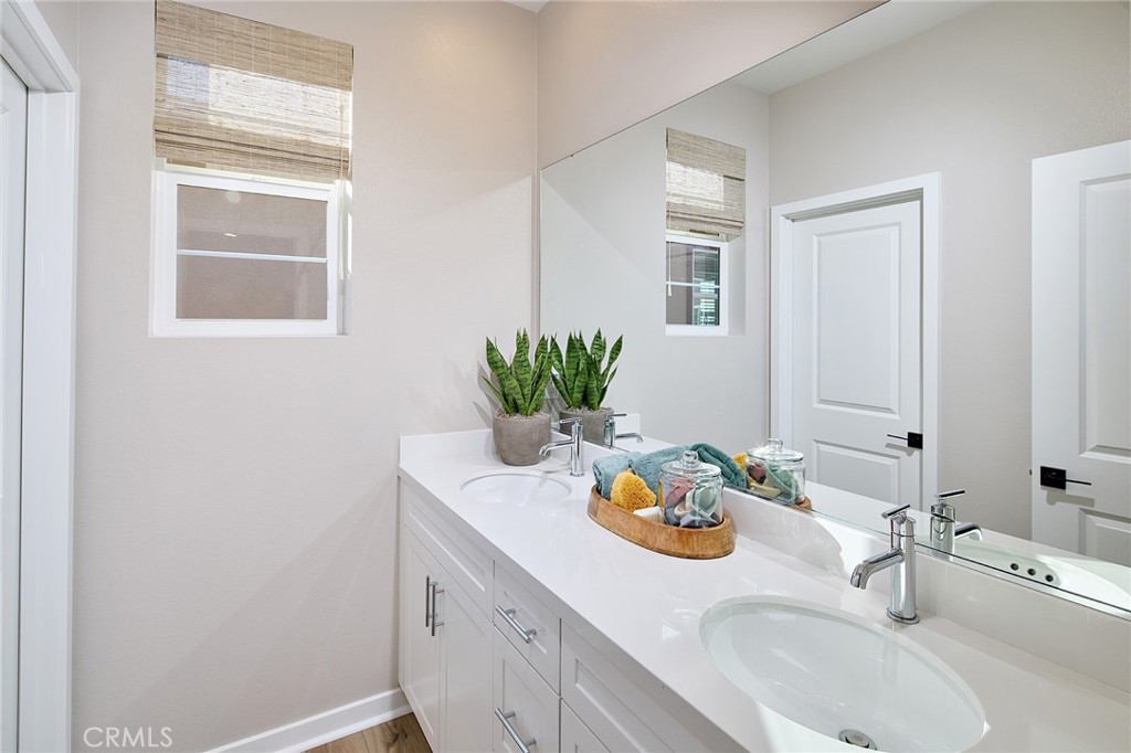 12706 Rosemount Road Eastvale, CA 92880 - Photo 10 of 25 a bathroom with a granite countertop sink and a mirror