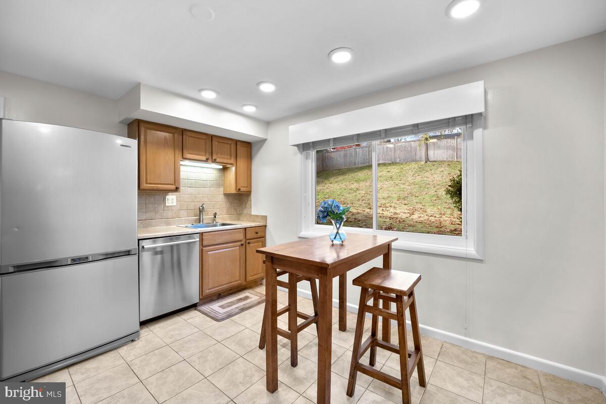 413 Waterford Road Silver Spring, MD 20901 - Photo 12 of 48 a kitchen with a table and chairs in it