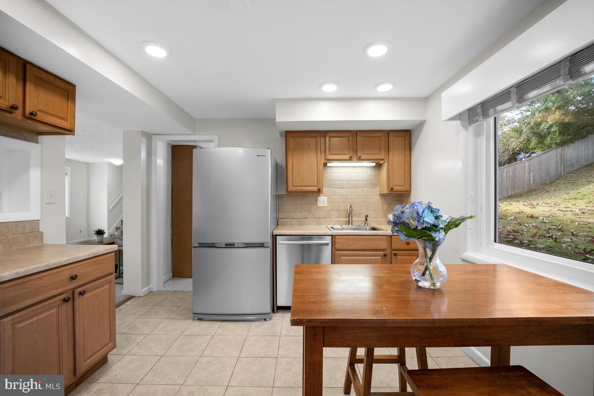 413 Waterford Road Silver Spring, MD 20901 - Photo 15 of 48 a kitchen with a table and chairs in it