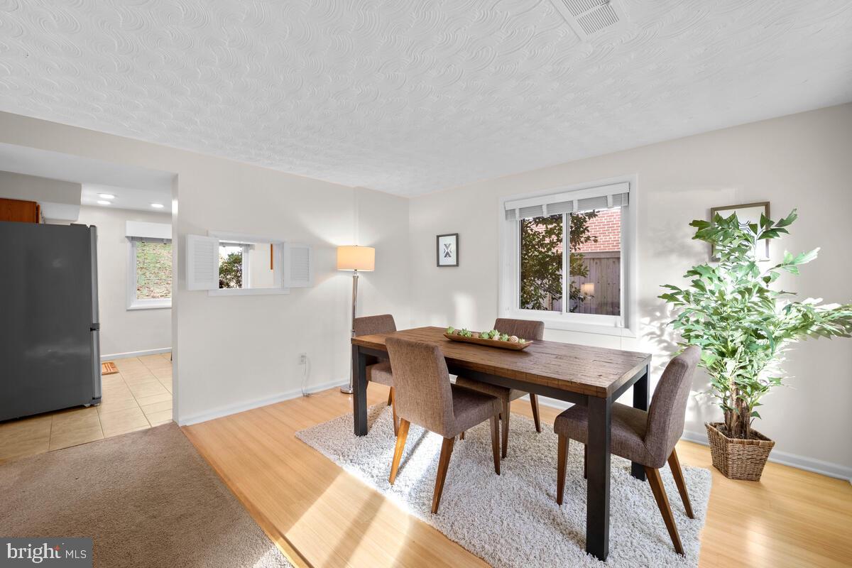 413 Waterford Road Silver Spring, MD 20901 - Photo 16 of 48 a view of a dining room with furniture and wooden floor