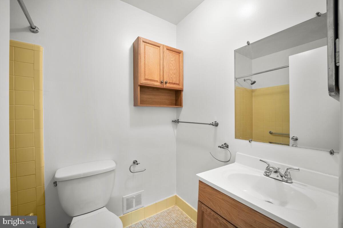 413 Waterford Road Silver Spring, MD 20901 - Photo 25 of 48 a bathroom with a sink mirror and toilet