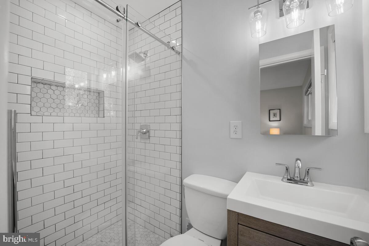 413 Waterford Road Silver Spring, MD 20901 - Photo 32 of 48 a bathroom with a sink toilet vanity and shower