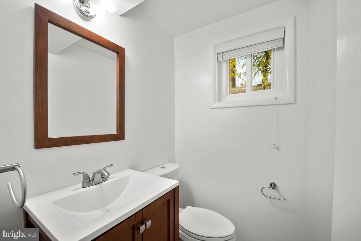 413 Waterford Road Silver Spring, MD 20901 - Photo 36 of 48 a bathroom with a toilet sink vanity and mirror