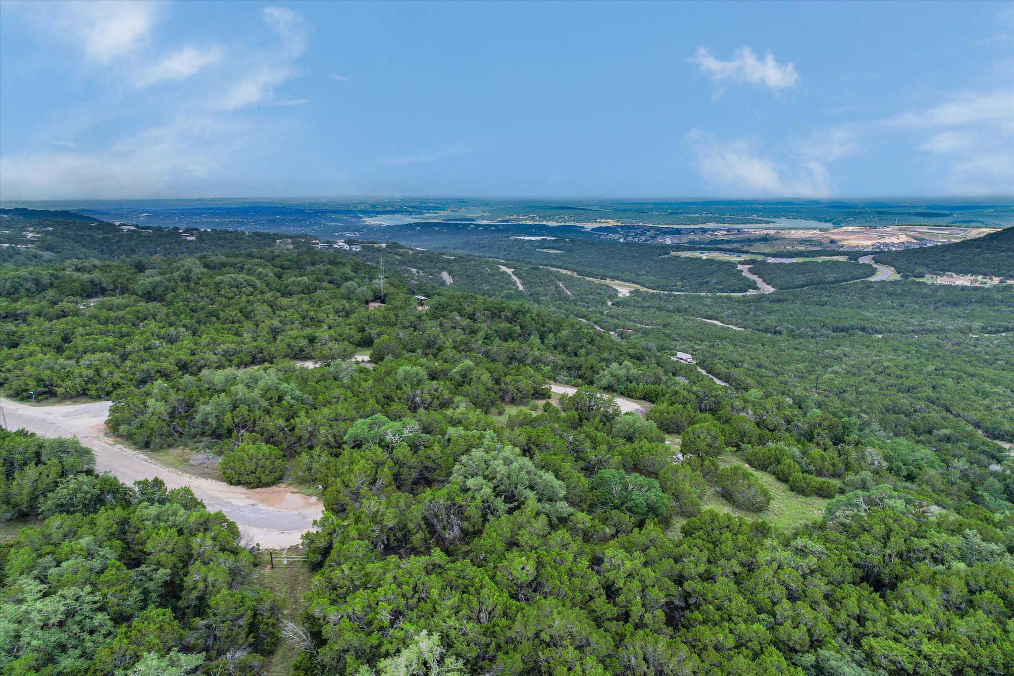 Vast, verdant landscapes stretch towards the distant horizon under an open sky.
