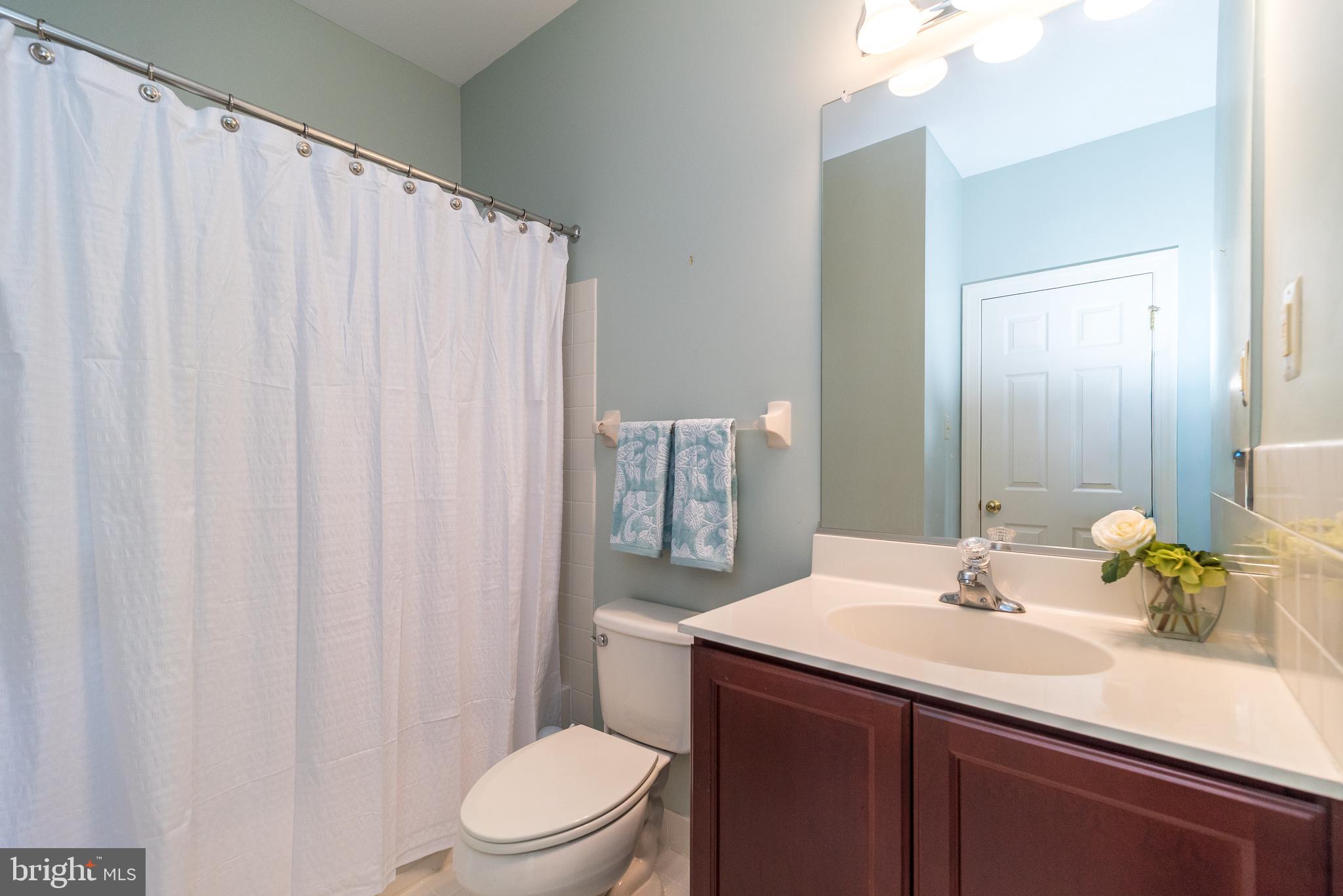 114 West Kennedy Road, Unit 189 North Wales, PA 19454 - Photo 16 of 43 a bathroom with a sink a toilet and shower curtain
