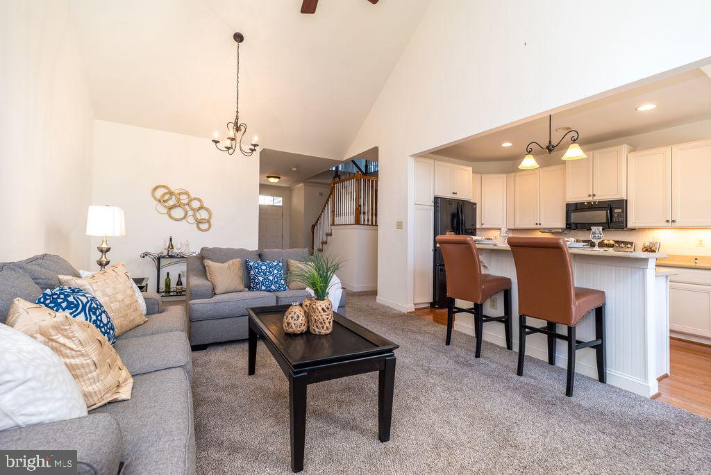 114 West Kennedy Road, Unit 189 North Wales, PA 19454 - Photo 3 of 43 a living room with furniture kitchen view and a chandelier