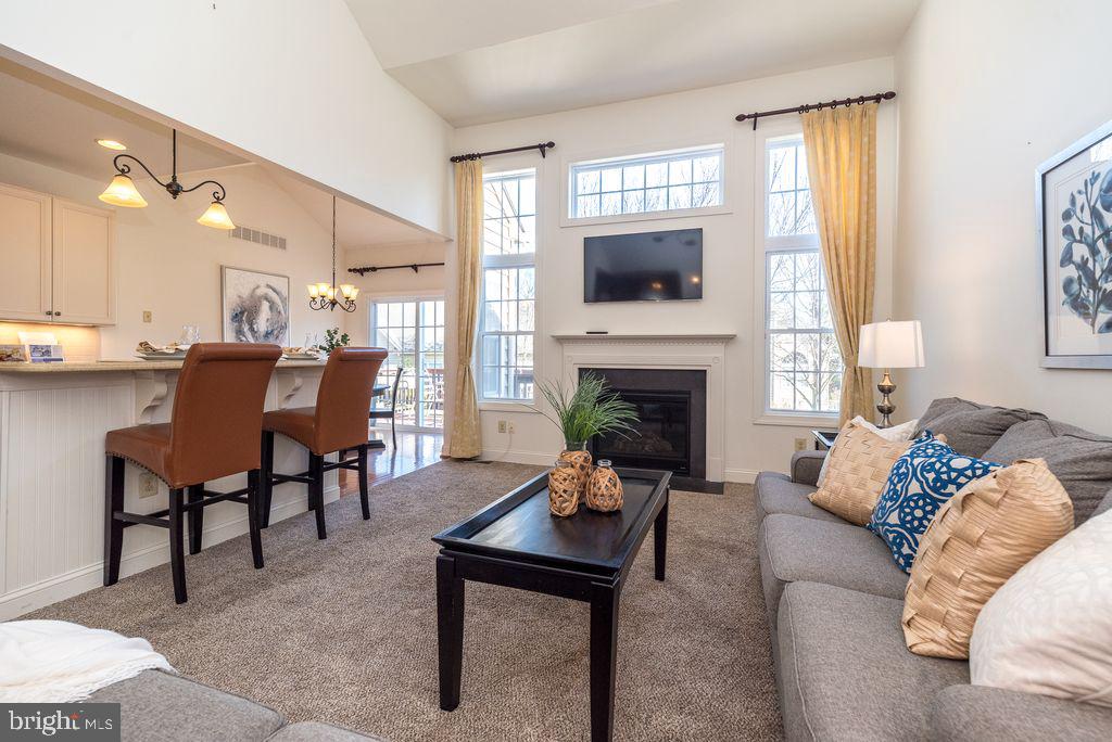 114 West Kennedy Road, Unit 189 North Wales, PA 19454 - Photo 4 of 43 a living room with furniture a flat screen tv and a fireplace