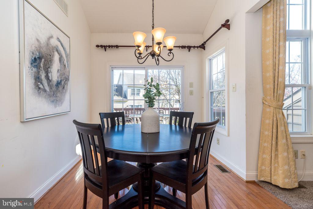 114 West Kennedy Road, Unit 189 North Wales, PA 19454 - Photo 10 of 43 a view of a dining room with furniture wooden floor and chandelier