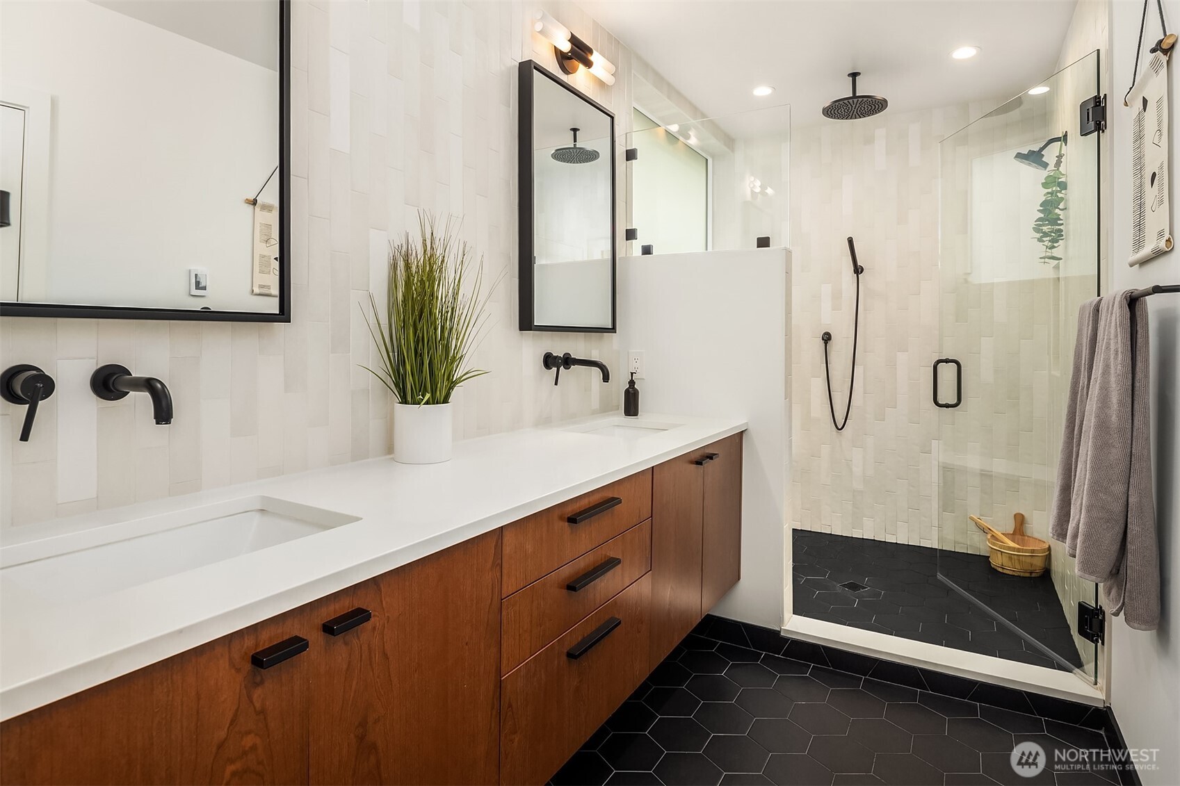 4005 Corliss Avenue North Seattle, WA 98103 - Photo 17 of 40 a bathroom with a double vanity sink a mirror and shower