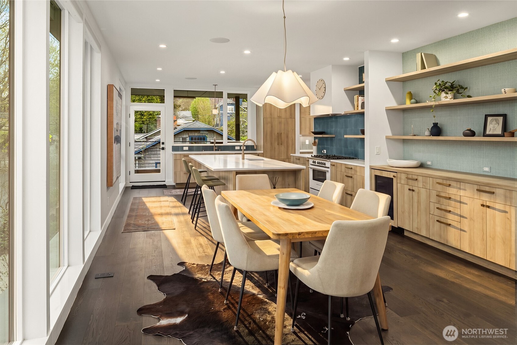 4005 Corliss Avenue North Seattle, WA 98103 - Photo 7 of 40 a view of a dining room with furniture a kitchen and chandelier