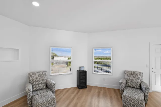 a bathroom with a toilet sink vanity granite and shower
