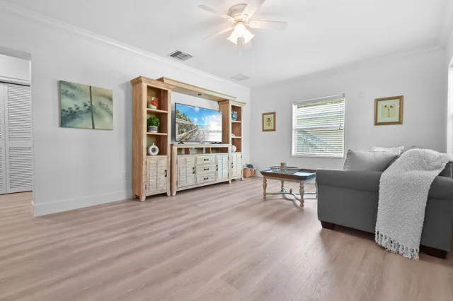 a living room with furniture a chandelier and a window