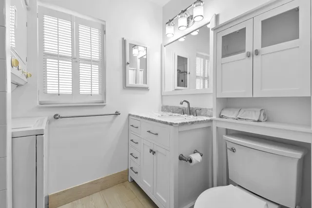 a bathroom with a mirror a shower and a sink