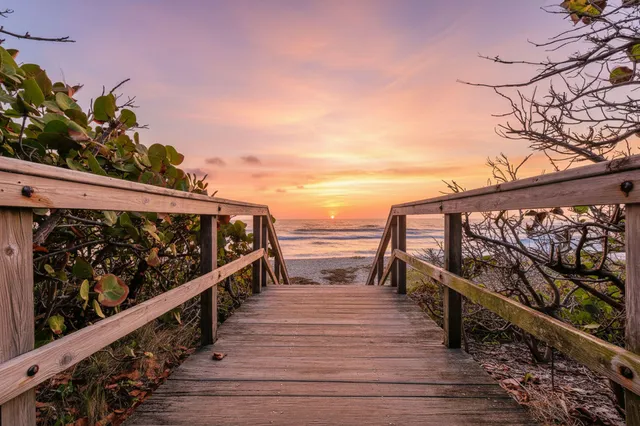a view of a roof deck with wooden floor and fence
