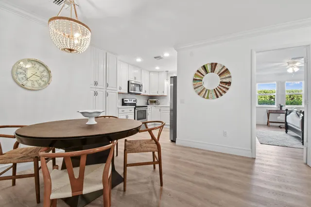 a view of a dining room with furniture and chandelier