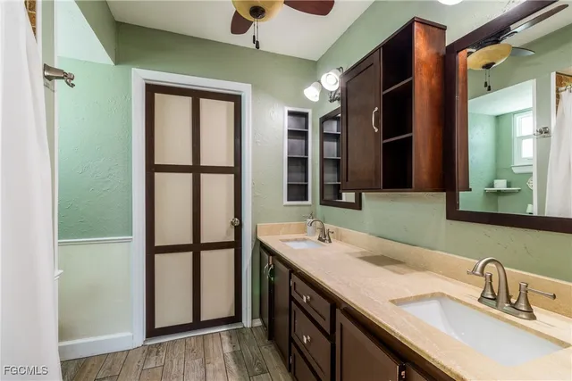 a en suite bathroom with a sink a toilet and a mirror