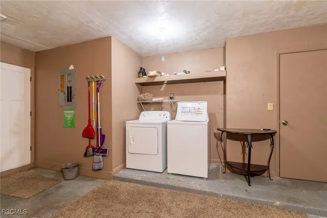 a dining room with furniture and a floor to ceiling window