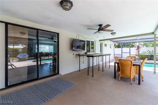 a view of a patio with couches chairs and a table and chairs with wooden floor