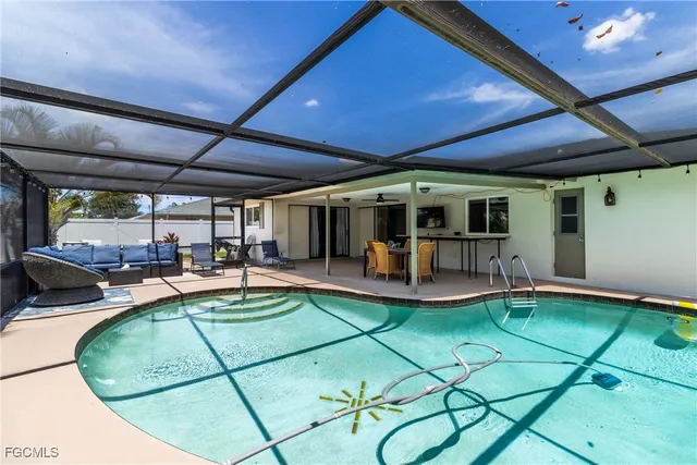 a view of a backyard with table and chairs under an umbrella