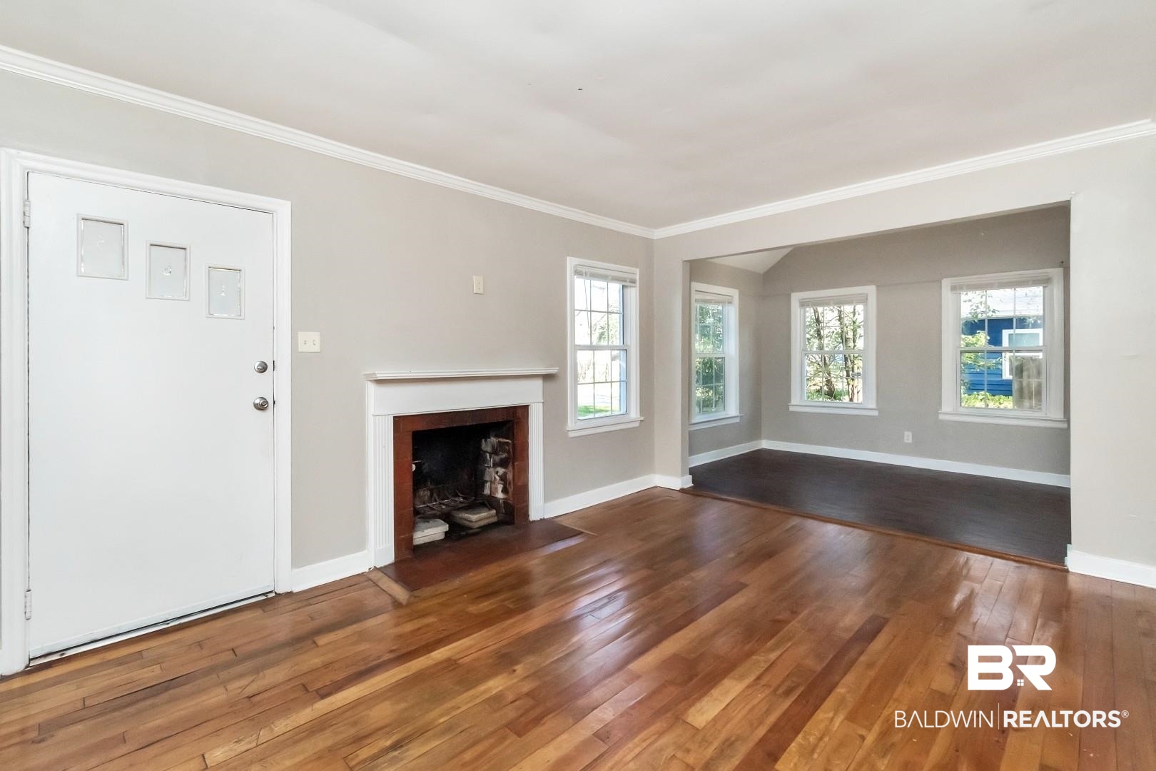 165 East Collins Street Mobile, AL 36606 - Photo 3 of 19 Unfurnished living room with a wealth of natural light, crown molding, and hardwood / wood-style floors
