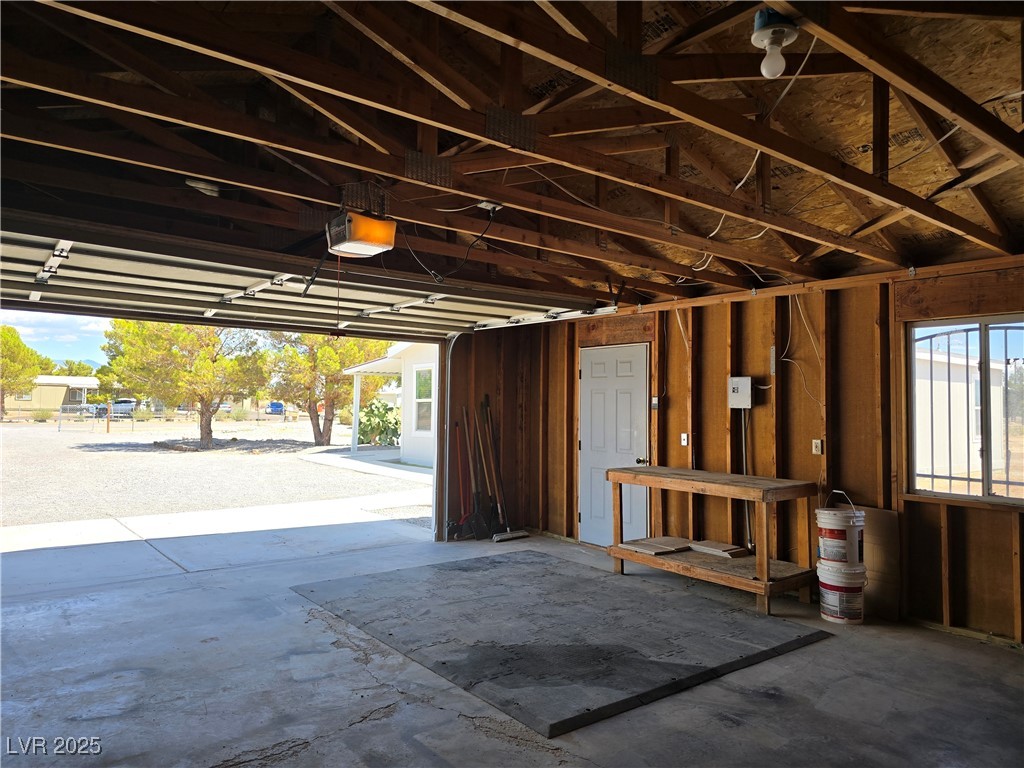 330 Gilmore Road Pahrump, NV 89060 - Photo 27 of 42 Garage has side entrance door, work bench, & part