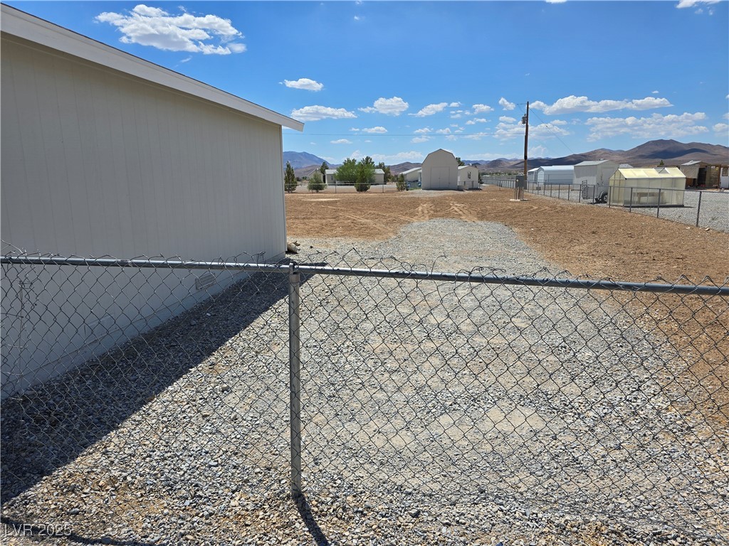 330 Gilmore Road Pahrump, NV 89060 - Photo 28 of 42 Right side of garage with graveled RV/storage cont