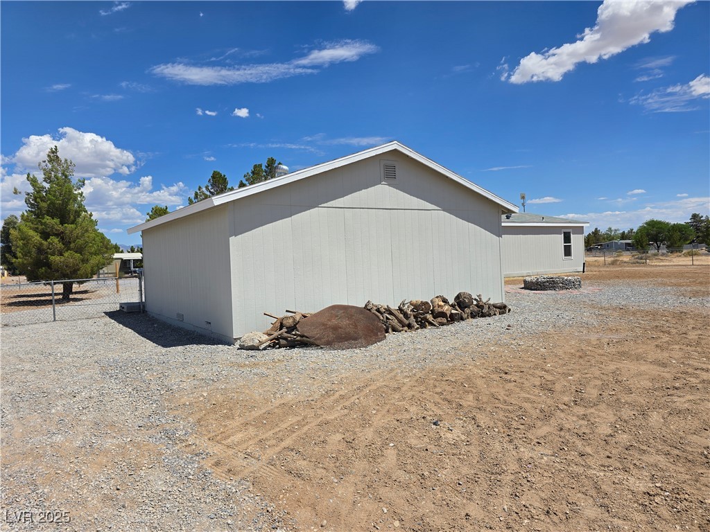 330 Gilmore Road Pahrump, NV 89060 - Photo 29 of 42 Back of garage with wood for firepit.