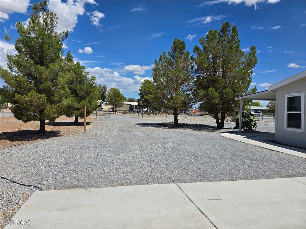 330 Gilmore Road Pahrump, NV 89060 - Photo 6 of 42 Driveway view from garage door pad to front gate.