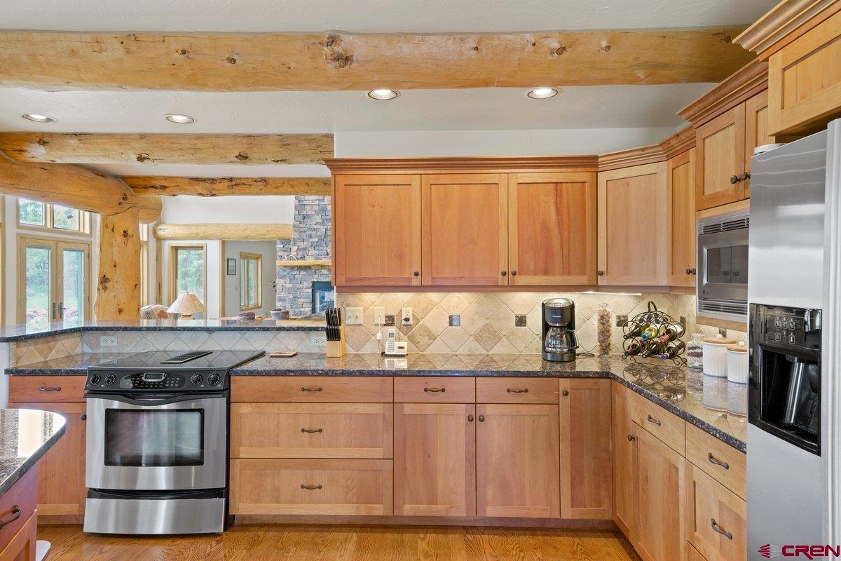 800 Pine Drive Ridgway, CO 81432 - Photo 11 of 35 a kitchen with granite countertop a sink and cabinets