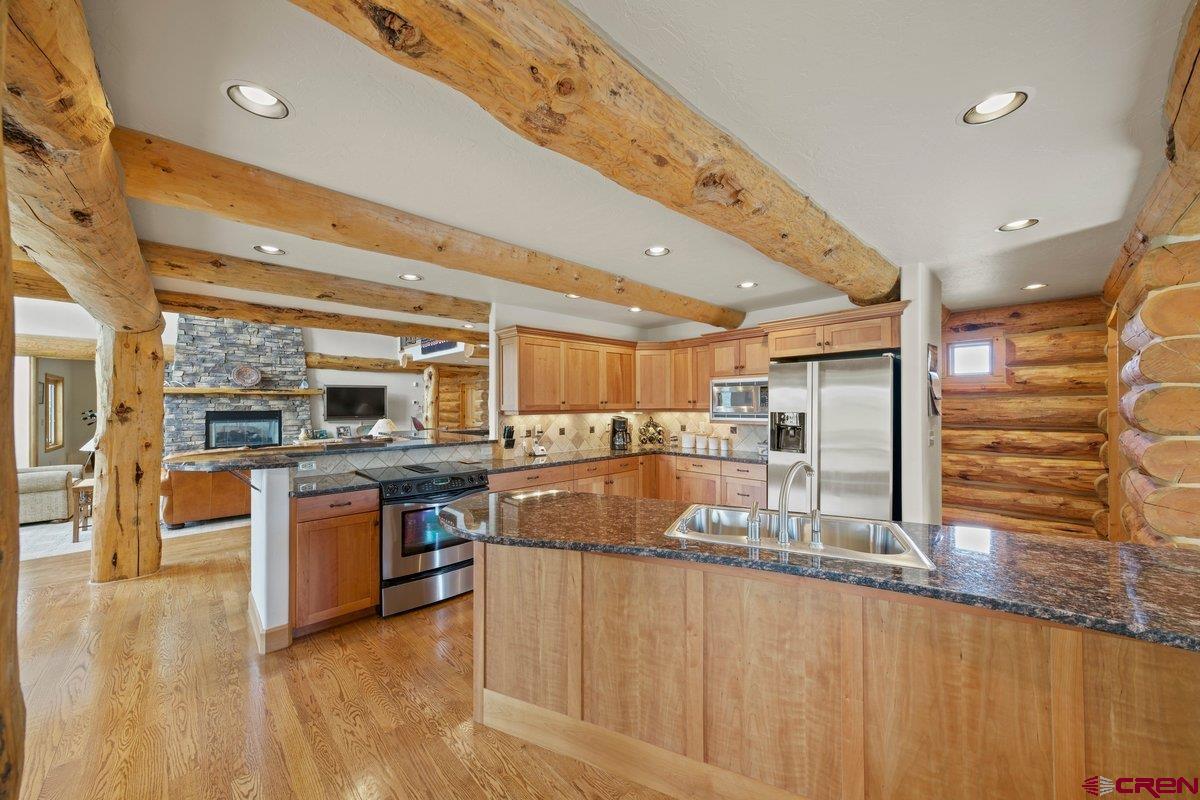 800 Pine Drive Ridgway, CO 81432 - Photo 12 of 35 a kitchen with stainless steel appliances granite countertop a sink and cabinets