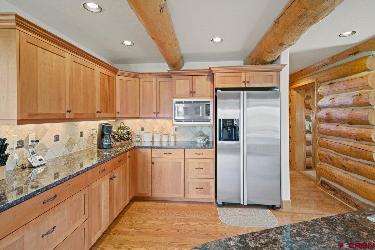 800 Pine Drive Ridgway, CO 81432 - Photo 13 of 35 a kitchen with stainless steel appliances granite countertop a refrigerator and a sink