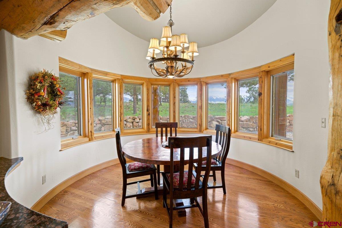800 Pine Drive Ridgway, CO 81432 - Photo 15 of 35 a view of a dining room with furniture wooden floor and chandelier