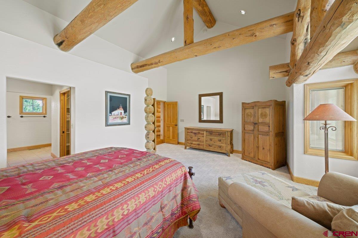 800 Pine Drive Ridgway, CO 81432 - Photo 17 of 35 a bedroom with a bed dresser and a window