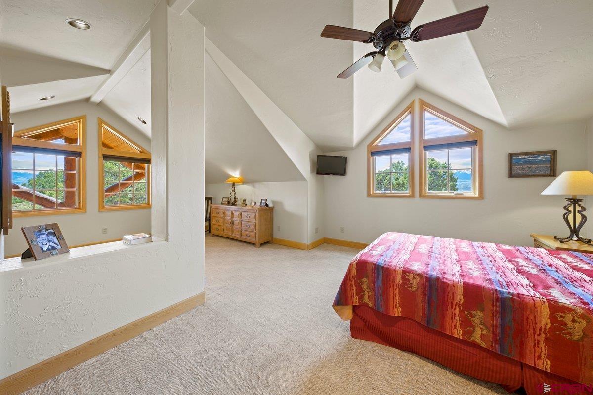 800 Pine Drive Ridgway, CO 81432 - Photo 20 of 35 a bedroom with a bed next to a window