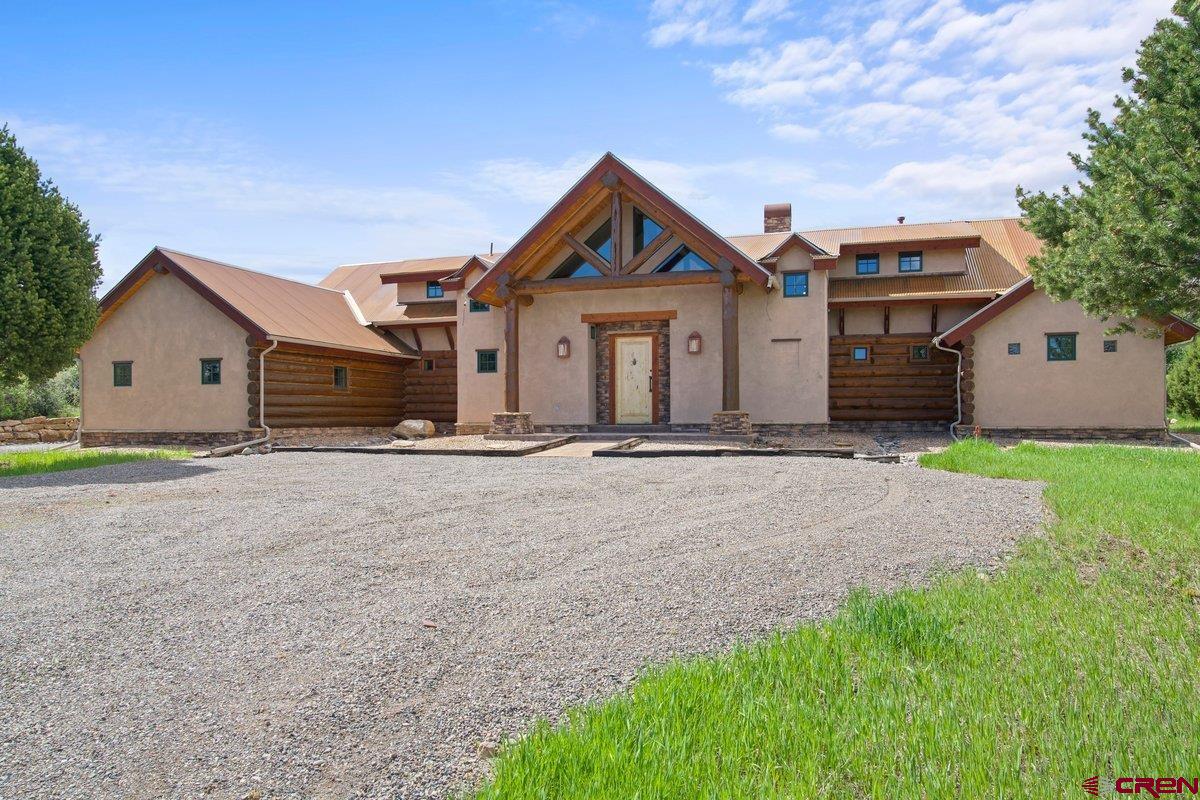 800 Pine Drive Ridgway, CO 81432 - Photo 3 of 35 a front view of a house with a yard and garage