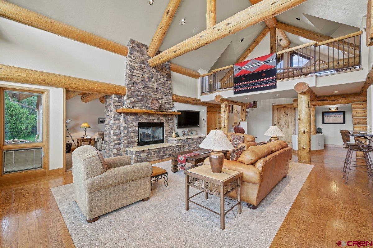 800 Pine Drive Ridgway, CO 81432 - Photo 10 of 35 a living room with furniture a fireplace and a ceiling fan