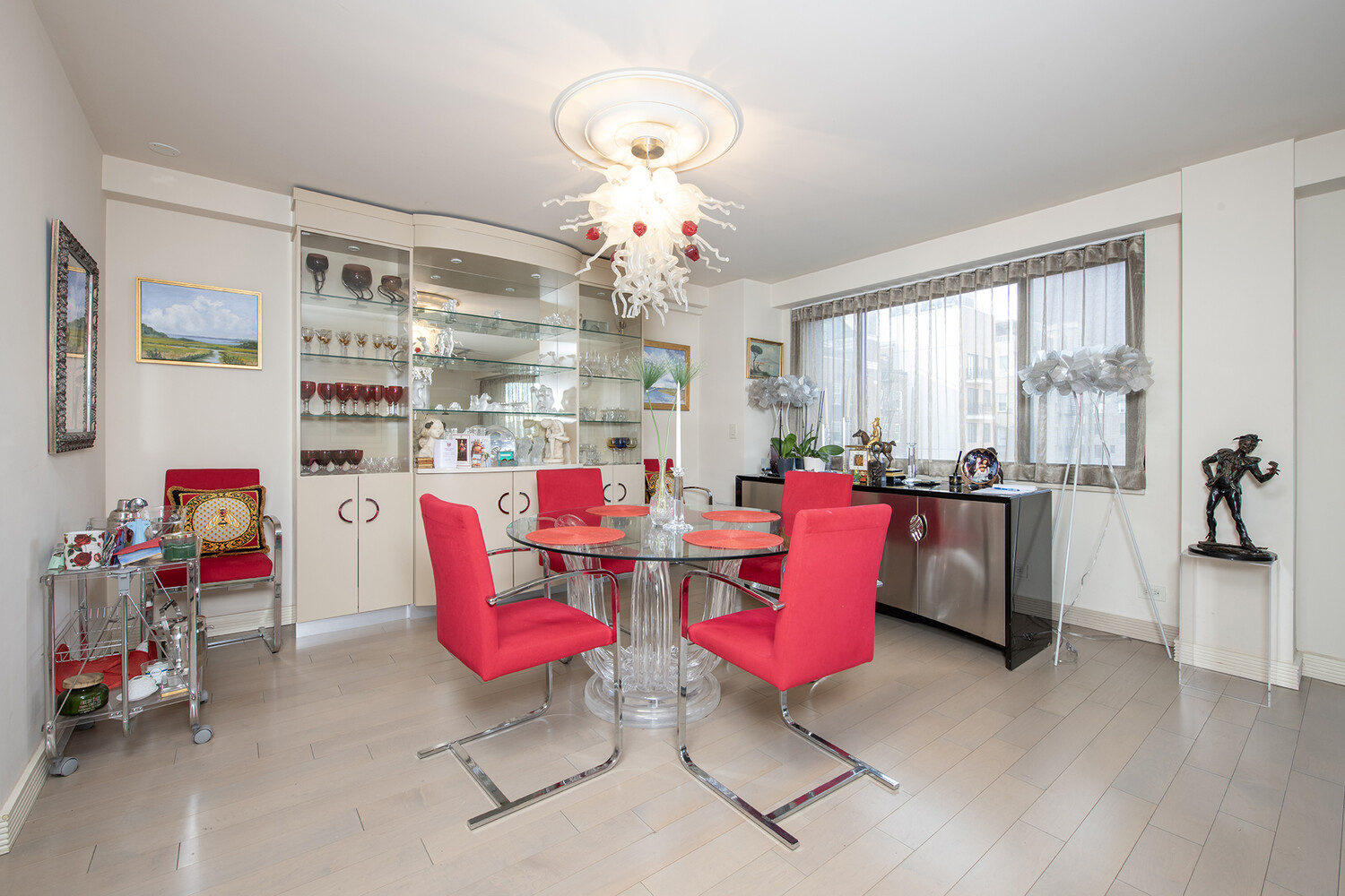 40 East 80th Street, Unit 15A Manhattan, NY 10075 - Photo 3 of 9 a living room with furniture gym equipment and a chandelier