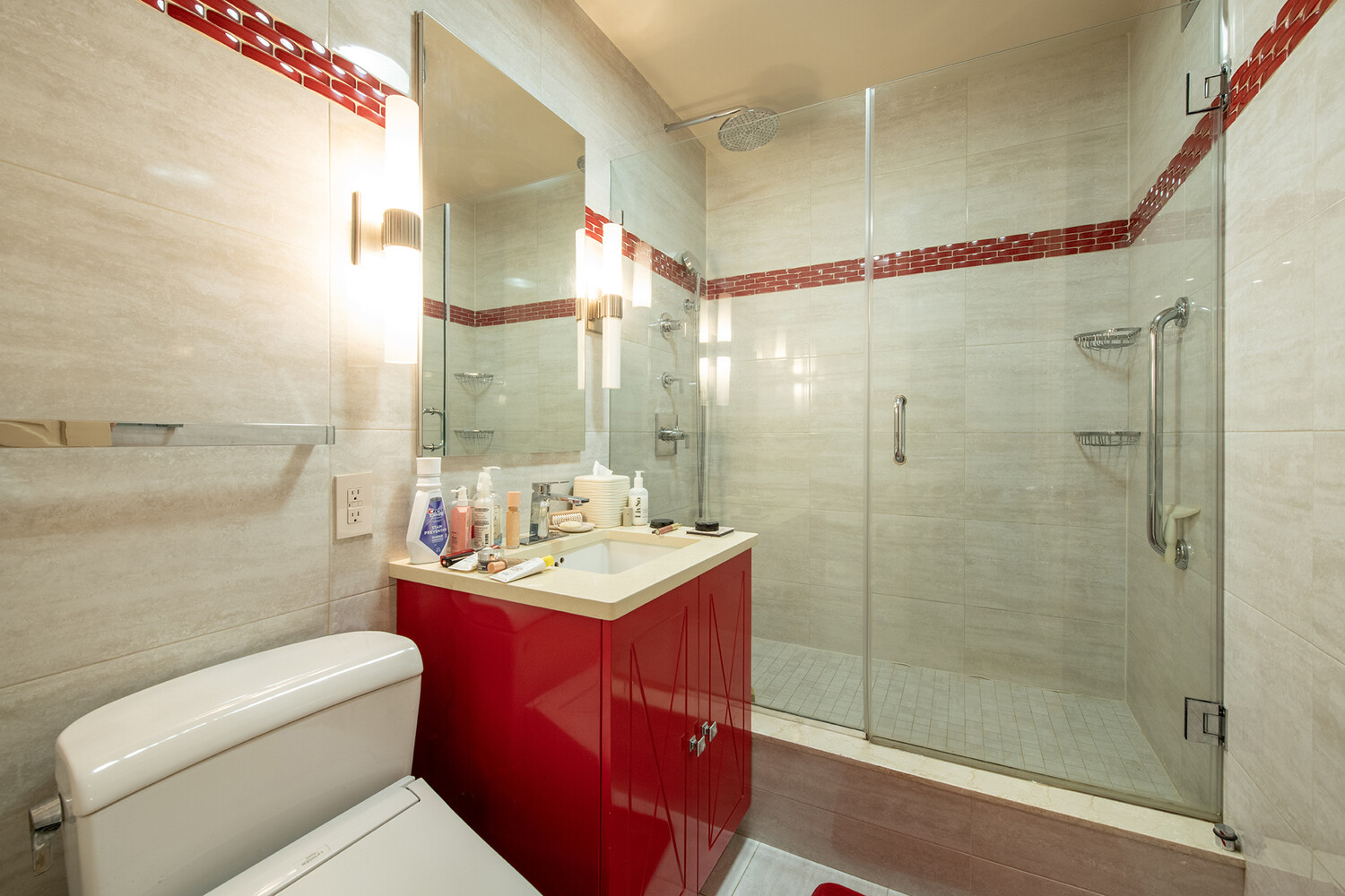 40 East 80th Street, Unit 15A Manhattan, NY 10075 - Photo 8 of 9 a bathroom with a sink toilet vanity and shower