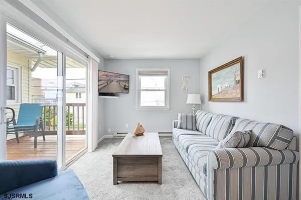 a spacious bedroom with a large bed couch and a large window