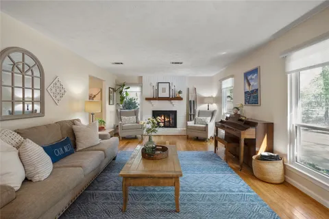 a living room with furniture couches and a fireplace