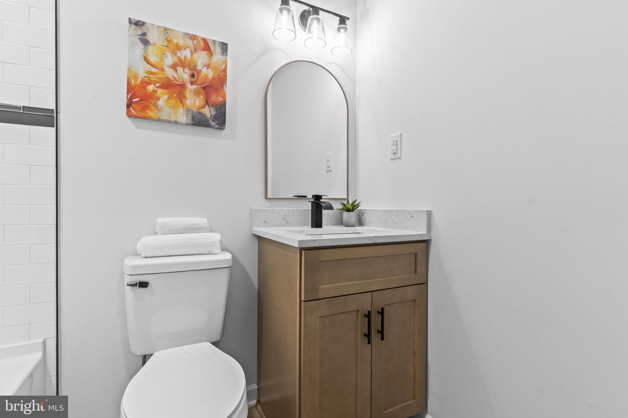 425 Rodeo Road Lusby, MD 20657 - Photo 21 of 33 a bathroom with a toilet a sink and mirror
