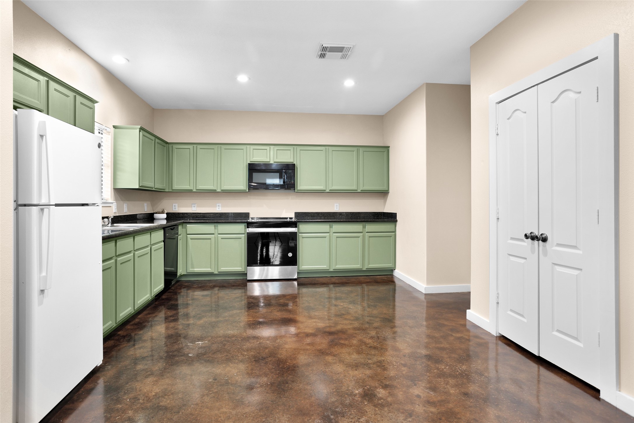 3129 Molly Huntsville, TX 77340 - Photo 11 of 31 a kitchen with kitchen island a sink a refrigerator and a stove top oven