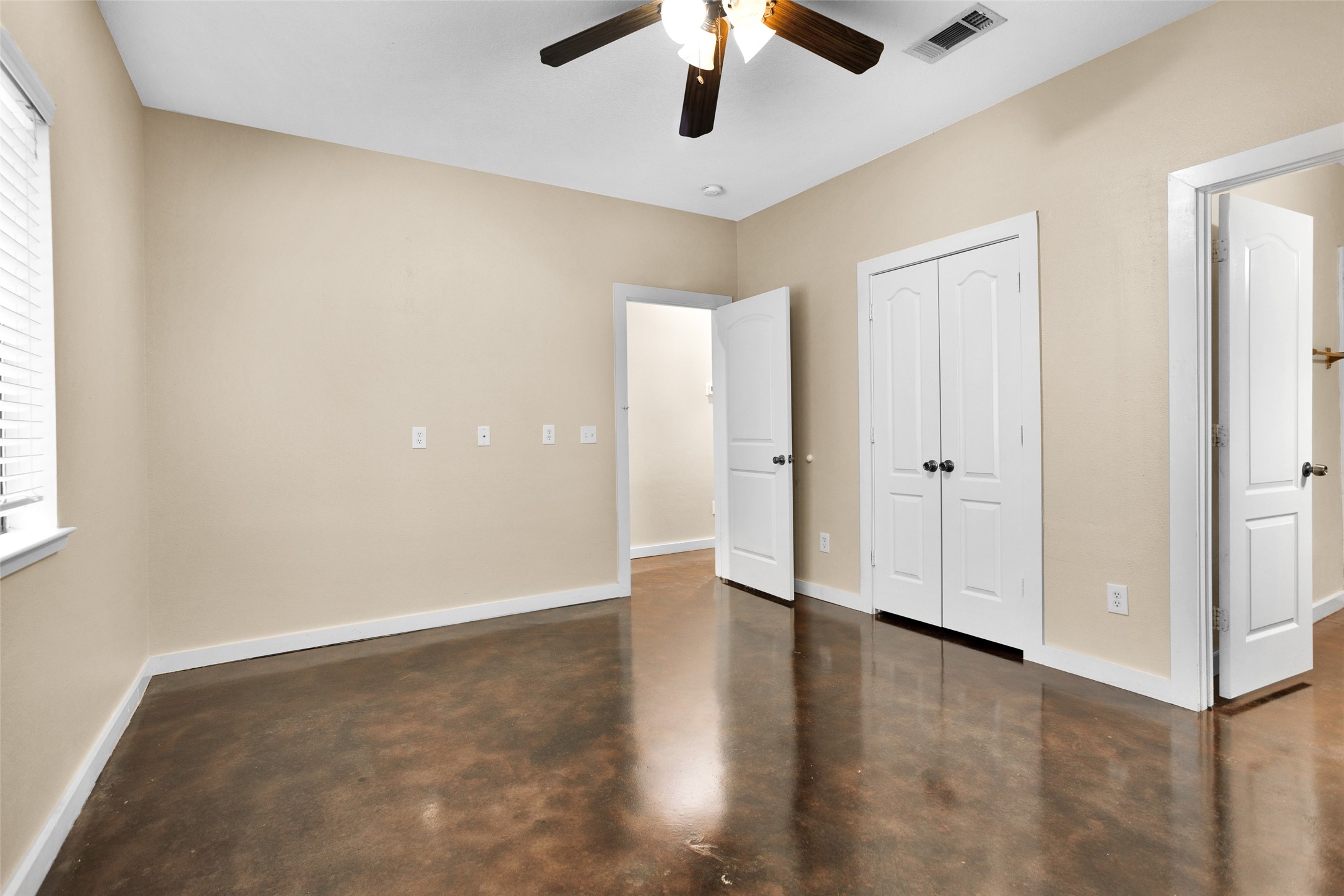 3129 Molly Huntsville, TX 77340 - Photo 23 of 31 an empty room with wooden floor chandelier fan and windows