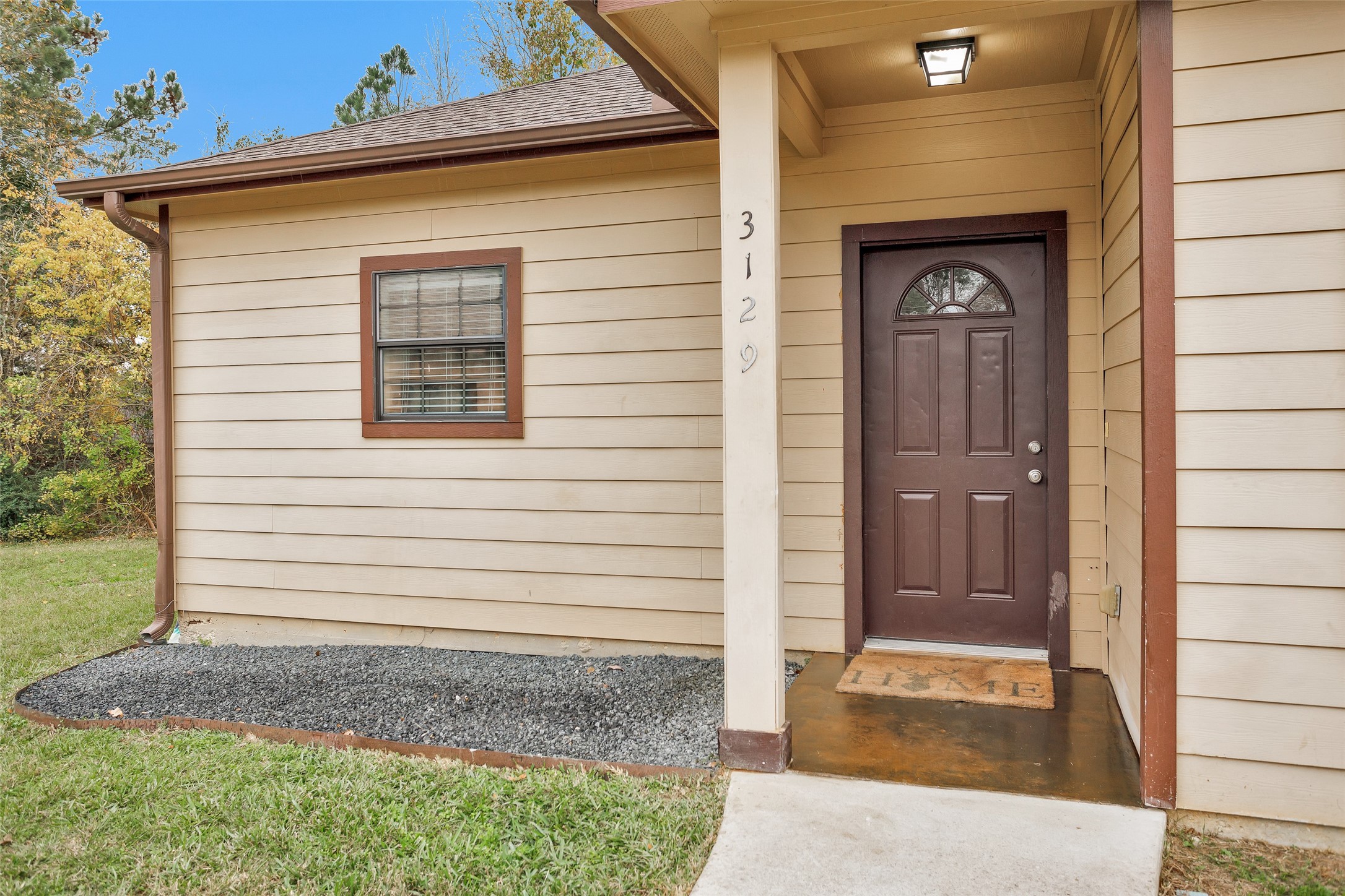 3129 Molly Huntsville, TX 77340 - Photo 3 of 31 a front view of a house with a yard